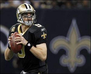 New Orleans Saints quarterback Drew Brees drops back to pass during the second half of an NFL wild card playoff football game against the Detroit Lions in New Orleans.