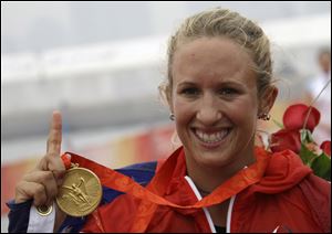 Anna Tunnicliffe, a Perrysburg graduate, displays her gold medal at the medal ceremony of the Laser Radial women class sailing competition at the 2008 Beijing Games.