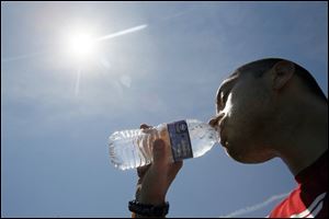 Kodyak Morris, Northwood, beats the heat with a bottle of water, Wednesday, June 27, 2012. Morris was taking a break to rehydrate while playing basketball with friends at Central Park in Northwood. According to a new Washington Post-Stanford University poll, just 18 percent of Americans interviewed named climate change as the world's top environmental problem. In 2007, when Al Gore's warning documentary and a United Nations report made headlines, 33 percent called climate change the top issue.