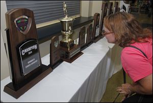 Lori Kertesz looks at one of the many trophies displayed at UT's Celebration of Champions. She is the mother of Emma Kertesz, a Central Catholic grad and All-American runner in track and field.