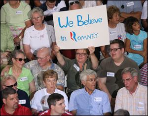 Some supporters of Mr. Romney hold signs during the Bowling Green event.