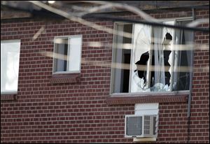 Windows are broken at the apartment of the alleged gunman James Holmes, 24, Friday.