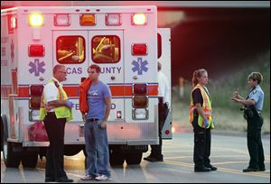 Toledo safety officials gather at the scene of the crash. Two pedestrians were struck Saturday night on Miami Street near I-75. 