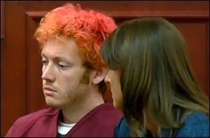 James Holmes, left, the suspected gunman in Friday's Colorado theater massacre, makes his first appearance in court with his attorney in Aurora, Colo.