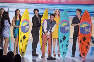 From left, Kat Graham, Nina Dobrev, Ian Somerhalder, Michael Trevino, Candice Accola, and Paul Wesley accept the choice fantasy/sci-fi show award for The Vampire Diaries at the Teen Choice Awards on Sunday.