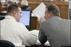 Samuel Williams, left, speaks with his attorney, John Thebes, during his murder trial.  He could face the death penalty for the 2011 killing of Johnny Clarke and Lisa Straub in Springfield Township. 