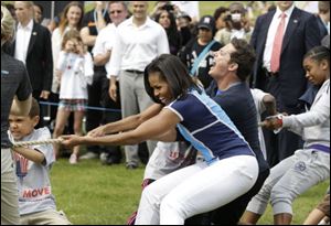 Michelle Obama plays with schoolchildren during a 'Let's Move!' event at the U.S. ambassador's residence in London, ahead of the 2012 Summer Olympics