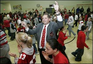 Students and faculty at Crossgates Elementary School in Toledo form 'Script Ohio,' around Jon Waters during a visit by Mr. Waters and some of the band members to the school in November, 2007. Mr. Waters' mother, Cheryl, was a TPS teacher and administrator.  