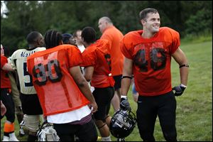 Anthony Coleman, a Montpelier Junior High School teacher, shares a laugh with his teammates on the Fulton County Bengals, a semi-pro team based in Delta, Ohio.