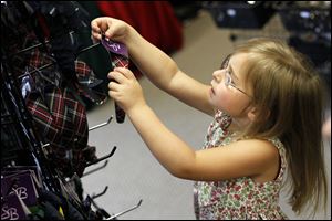 Emma Kate Lehman, 4, tries on headbands.