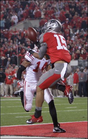 Ohio State's Devin Smith, right, catches the game-winning touchdown as Wisconsin's Marcus Cromartie defends.