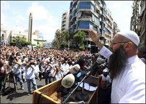 Lebanese cleric Ahmad al-Assir seeks support for Syrian rebels after prayers in Beirut.