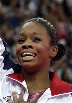 U.S. gymnast Gabrielle Douglas acknowledges the audience after being declared winner of the gold medal during the artistic gymnastics women's individual all-around competition at the 2012 Summer Olympics.