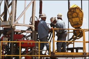 Workers get down to business on a drilling rig near Calumet, Okla. Oklahoma is one of several states including North and South Dakota, that has enjoyed a boom in the energy source.