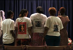 Mourners, including Tamatha Hamilton, right, an aunt of Keondra Hooks, 1, pay their respects at Tate Funeral Services. Keondra died in what police say was a gang-related shooting at Moody Manor.