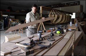 John Riddle works on the replica of the 19-foot pulling boat in which Commodore Oliver Hazard Perry was rowed to safety during the Battle of Lake Erie against the British fleet near Put-in-Bay, Ohio.