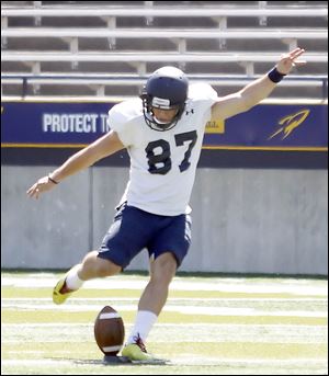 UT football player Brad Dunavant kicks the ball  during practice in the Glass Bowl on Saturday.