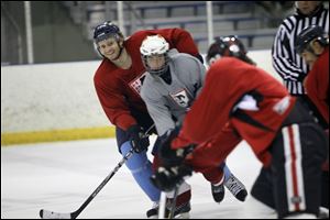 Toledo Walleye player Kyle Rogers, left, helped during the 10-week skating camp.