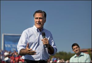 Republican presidential candidate Mitt Romney speaks Saturday as vice presidential running mate Rep. Paul Ryan, R-Wis., listens during a campaign rally in Powell, Ohio.