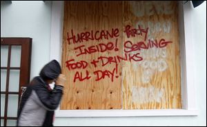 An invitation to a party greets a lone passer-by on a street in Key West. Scattered power outages were reported from Key West to Fort Lauderdale, Fla., Sunday, affecting more than 16,000 customers.