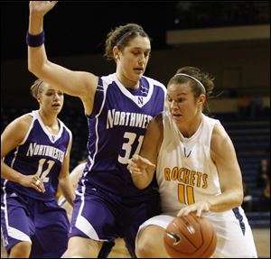 University of Toledo's Allie Clifton dribbles around the defense of Northwestern's  Dannielle Diamant, left #31, and Allison Mocchi, back #12, during the  first half of the women's basketball home opener against Northwestern on November 13, 2009.