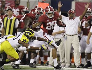 Alabama defensive back Dee Milliner returns an interception against Michigan's Jeremy Gallon. Alabama picked off three passes.