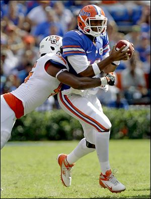 Florida quarterback Jacoby Brissett is tackled by BG defensive lineman Charlie Walker.