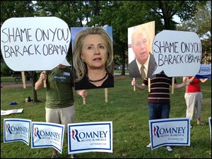 People stand outside Scott High School in protest of President Obama.