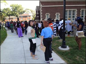 Priscilla Martinez, a field organizer with the Obama campaign, organizes the crowd in front of Scott High School hours before doors opened for Mr. Obama's speech.