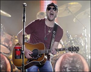 Eric Church performs on an outdoor stage during the CMT Music Awards show in Nashville, Tenn., earlier this summer.