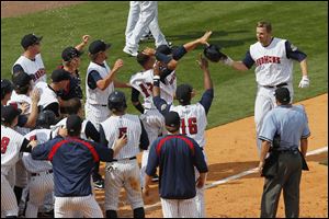 Brad Eldred, crossing home plate after a walk-off home run in May, led the Hens in homers despite going to Japan in June.