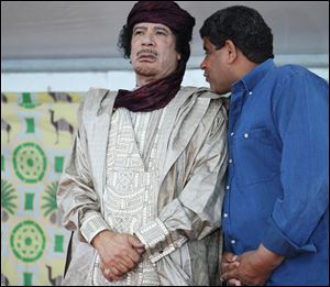 Intelligence chief Abdullah al-Senoussi, right, whispers to Libyan leader Moammar Gadhafi in Sabha, Libya. A government statement read on national radio states that Mauritania has agreed to extradite Moammar Gadhafi's former spy chief, months after he tried to slip into Mauritania wearing a disguise and traveling on a fake passport.