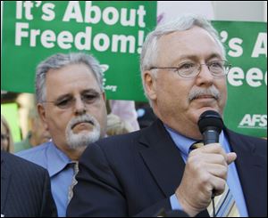 Tom Ritchie, Sr., center, and Dennis Lieberman, right, attend a rally last month for early voting.