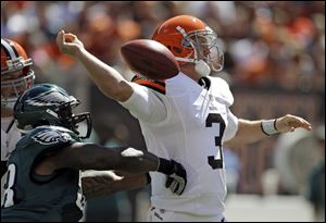 Cleveland's Brandon Weeden has the ball knocked from his hand on Sunday by Philadelphia defensive end Trent Cole. Besides the fumble, the Browns rookie threw four interceptions in the loss.