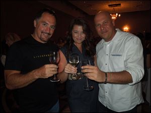 Jerry Brown, Lori Jacobs and Michael Seay pose for a photograph during the Wine for Wishes event. Proceeds went to benefit the Make-A-Wish Foundation.