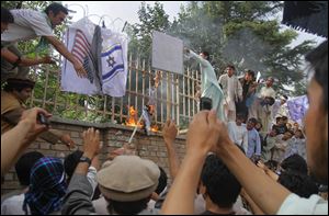 Afghans set fire to an American flag during a protest against an Internet video mocking the Prophet Mohammed. NATO and U.S. troops are working with Afghanistan to reduce the number of insider attacks on coalition forces.