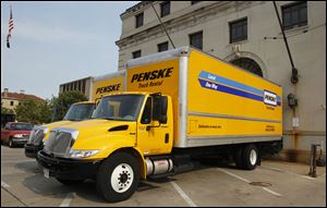 A pair of rental trucks are parked outside the Safety Building in Toledo.  They were allegedly taken by Toledo police during a drug bust.