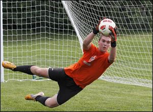 Goalie Eric Breeden stops a ball during soccer practice at Southview High School.