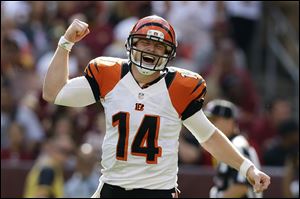 Cincinnati Bengals quarterback Andy Dalton reacts to a touchdown pass to wide receiver Andrew Hawkins during the second half of an NFL football game against the Washington Redskins in Landover, Md.