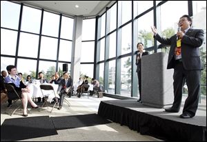 Simon Guo, the president of 5 Lakes Global, gives the keynote speech Tuesday at Fifth Third Center for the luncheon of the 5 Lakes Global International Economic Forum.