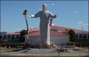 Workers put the finishing touches on the new Jesus statue 