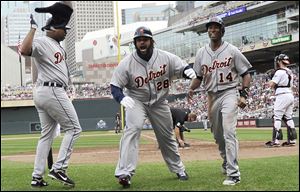 Detroit Tigers slugger Prince Fielder, center, celebrates with Delmon Young, left, and Austin Jackson after Fielder's two-run home run off Minnesota Twins pitcher Jared Burton in the eighth inning Sunday in Minneapolis. The Tigers won 2-1.