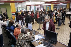 Voters wait to be checked in at the Lucas County early voting site at Summit Plaza in Toledo last fall.