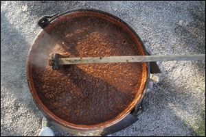 Apple butter bubbles and steams as it is stirred. Although it's the focal point of the festival, many other foods will be for sale too.