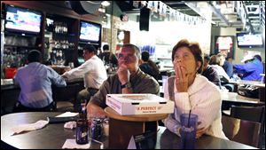 Scott and Tammy Crockett of Perrysburg, watch the presidential debate Wednesday at PizzaPapalis in Toledo.