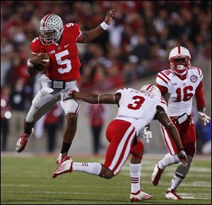 Ohio State quarterback Braxton Miller scrambles against  Nebraska defenders tonight in Columbus.