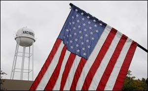 A United States flag and the water tower in Archbold.