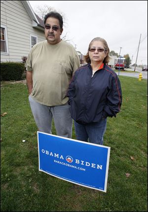 Joe and Diana Rocha display a campaign sign for President
Obama outside their Archbold home. The Rochas said one
night this week a young man in a pickup stopped at their
home shortly after midnight, took their Obama campaign
signs, and replaced them with Romney campaign signs.
They notified Archbold police and then replaced the Romney
signs with new Obama signs.