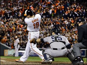 Baltimore Orioles' Chris Davis singles in the third inning of Game 2 of the American League division baseball series against the New York Yankees.