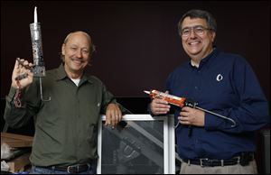 Brady Bancroft, left, and Joe Peschel of Owens Community College are to present free energy efficiency workshops in North and East Toledo. Participants at the events will get a free energy saver kit.